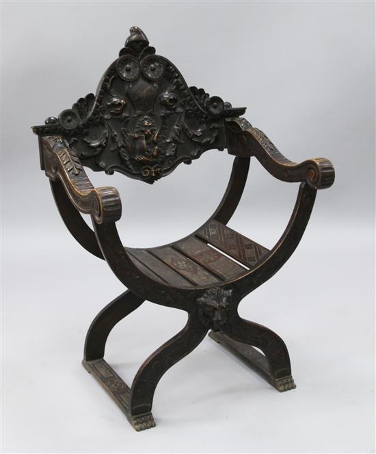 A late 19th century French carved walnut and beech Savonarola style chair, H.3ft 4in.
